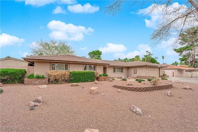 Ranch-style home with a garage, driveway, and stuc