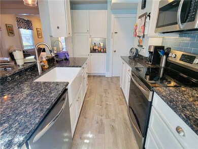 Modern galley kitchen with breakfast bar and stone countertops