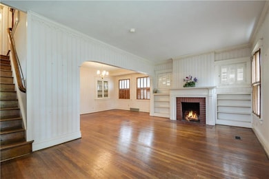 Real hardwood flooring, built-ins, open feeling.