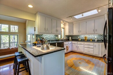 Kitchen is open to eat-in area and family room.  House gets great light.  Notice skylight and lots of windows with amazing views!