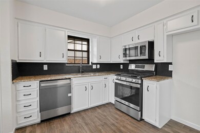 Kitchen with stone counters, stainless steel appli
