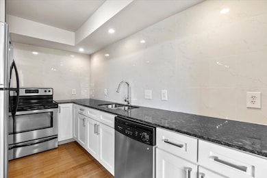 Kitchen with stainless steel appliances, a sink, 