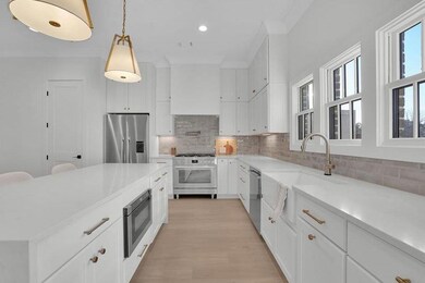 Kitchen with tasteful backsplash, sink, white cabi