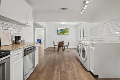 Washroom featuring wood-type flooring, a brick fir