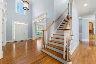 Entryway featuring wood finished floors, a high ce