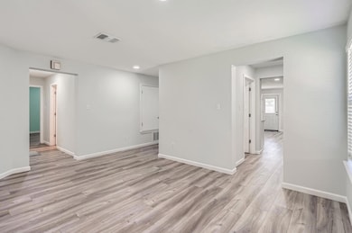 Empty room with light wood-style flooring and rec