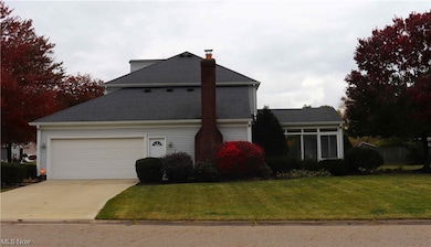 Front of property with a garage and a front lawn