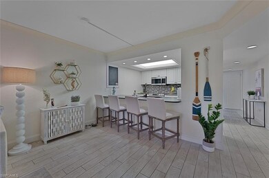 Kitchen featuring white cabinetry, light wood-type