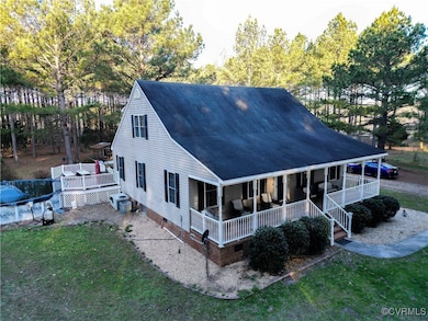 Rear view of property with crawl space, covered po