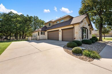 View of front of property with stone siding, an attached garage, concrete driveway, and roof with shingles