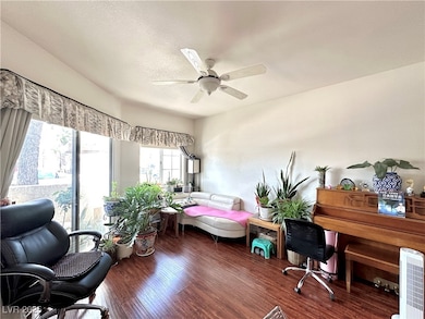 Office with wood finished floors and ceiling fan