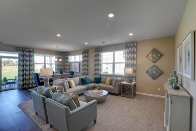 Living room & dining room with multiple windows letting in natural light and a nice breeze on a Fall Day! *Pictures are of model home, colors and finishes may vary. *