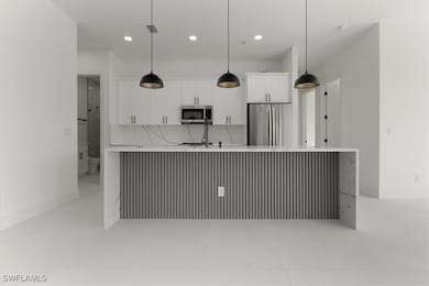 Kitchen with light tile patterned flooring, white