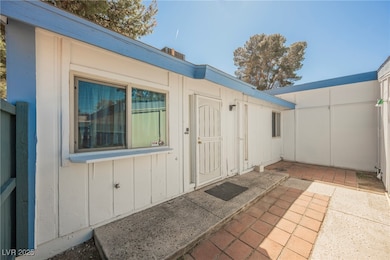 Doorway to property featuring a front fenced patio