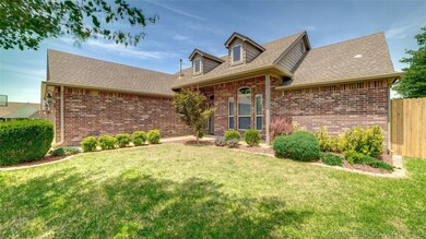Front of home with beautiful landscaping.