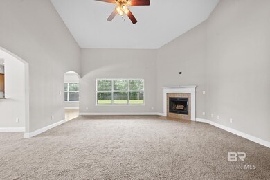 Unfurnished living room with carpet, a fireplace, ceiling fan, window treatments and high vaulted ceiling.