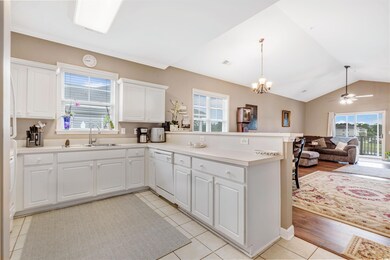 Kitchen featuring lofted ceiling, kitchen peninsul