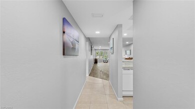 Corridor featuring light tile patterned floors, re
