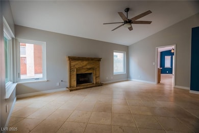 Unfurnished living room featuring ceiling fan, lof