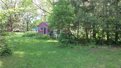 This backyard comes with a shed. Store your tools 