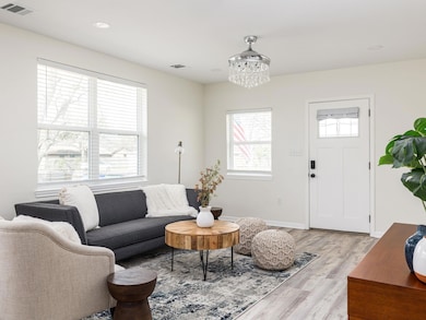 Living area featuring baseboards, visible vents, 