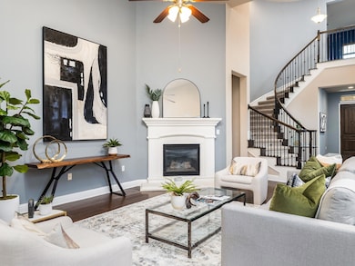Living area featuring stairway, baseboards, a cei