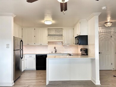 Kitchen featuring black appliances, a peninsula, 