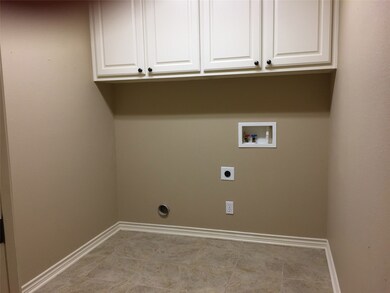 Spacious utility room with nice storage cabinets!