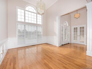 Large Formal Dining Room with High ceilings, hardwood floors, Dome top window and moldings throughout!
