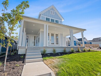View of front of property featuring board and batten siding, covered porch, and a front lawn