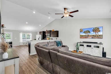 Living area with wood finished floors, ceiling fan