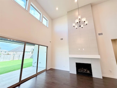 Unfurnished living room with a towering ceiling, 