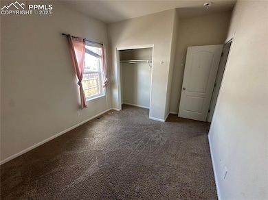 Unfurnished bedroom with carpet floors, baseboards