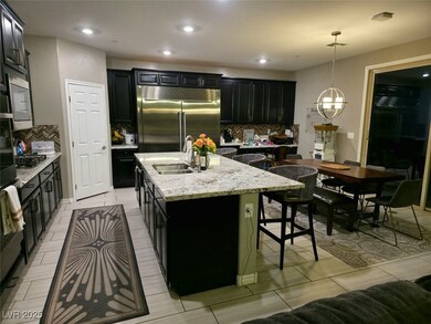 Kitchen with built in appliances, a sink, backspla