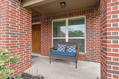 This inviting front porch features classic red bri