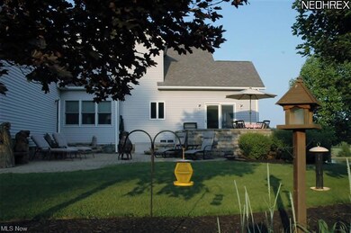 Rear multi-level patio surrounded by dwarf lilacs 