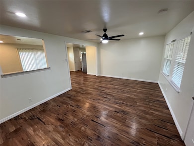 Unfurnished room with plenty of natural light, recessed lighting, dark wood-style floors, a ceiling fan, and a smoke detector