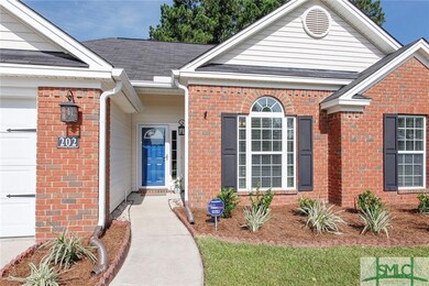 Front entryway is enhanced by lantern lighting and