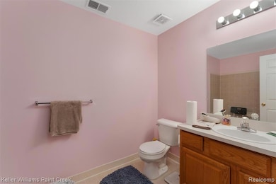 Bathroom with light tile patterned floors and vanity