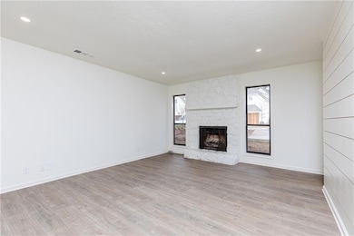 Living room with new flooring and paint, stone fir