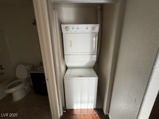 Laundry room featuring stacked washer and clothes