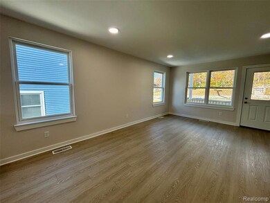 Empty room featuring wood finished floors and recessed lighting