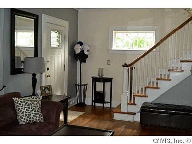 Foyer Elegant staircase and hardwood floors add to