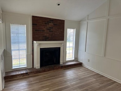 Unfurnished living room featuring hardwood / wood-