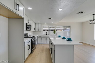 Kitchen featuring visible vents, a kitchen island,