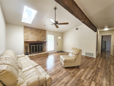 Living room featuring a brick fireplace, visible 