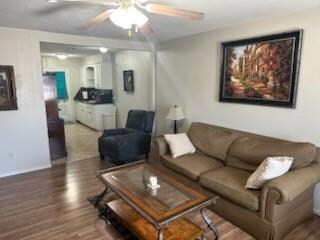 Living area featuring ceiling fan and wood finishe