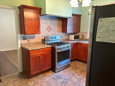 Kitchen featuring exhaust hood, decorative backspl