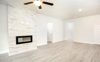 Unfurnished living room with a premium fireplace, 