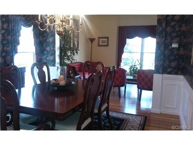Formal dining room has crown molding, chair rail a